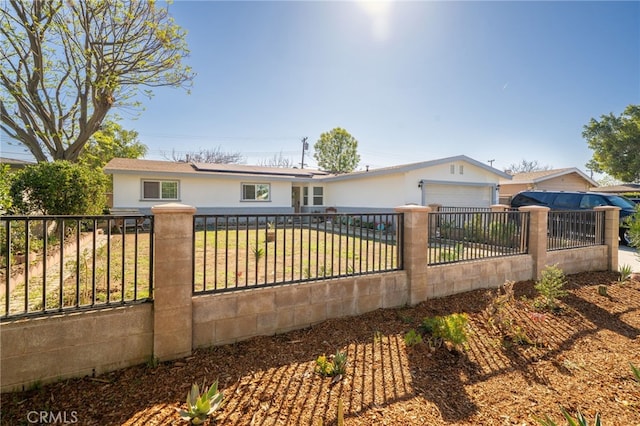 view of front of house featuring a fenced front yard and a garage