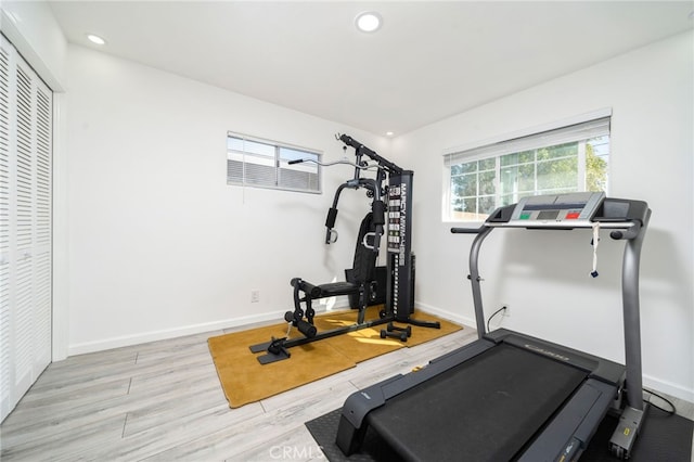 workout area featuring recessed lighting, baseboards, and wood finished floors