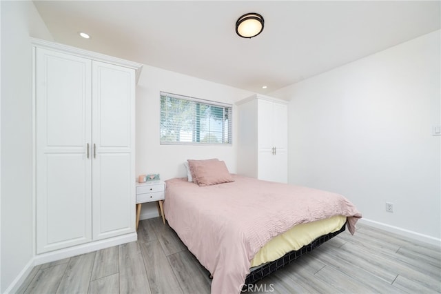 bedroom featuring recessed lighting, baseboards, and light wood finished floors