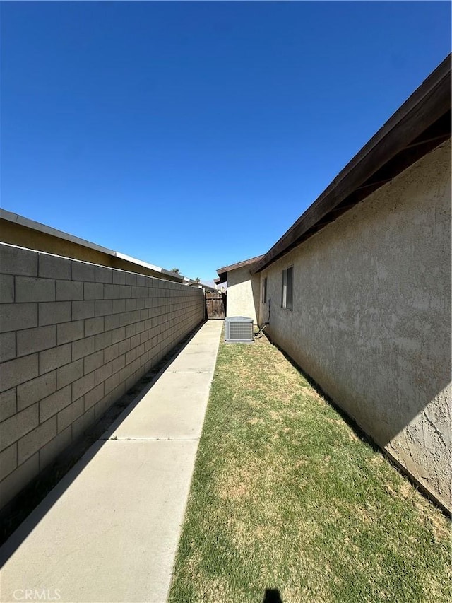 view of yard with cooling unit and a fenced backyard