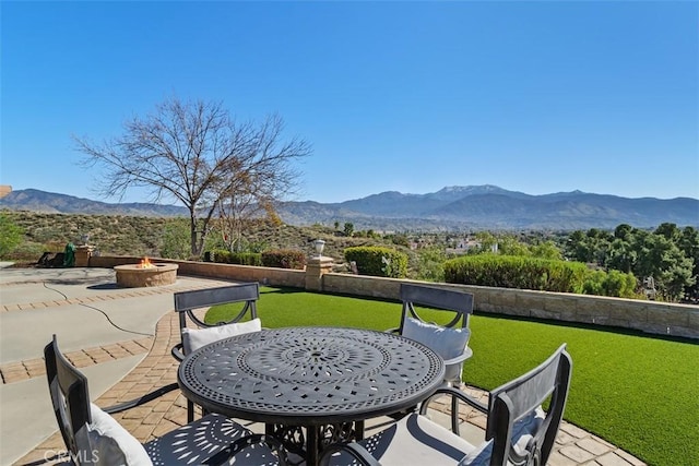 view of patio featuring a mountain view and an outdoor fire pit