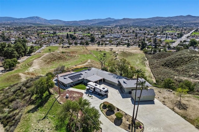 birds eye view of property with a mountain view