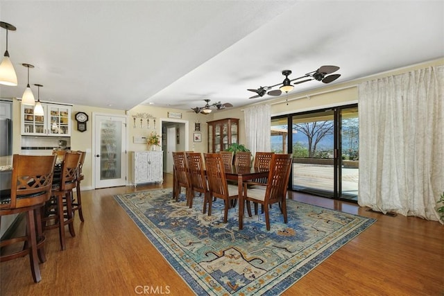 dining area featuring ceiling fan and wood finished floors