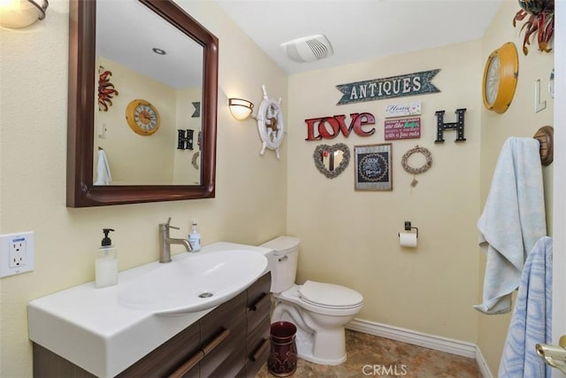 bathroom with visible vents, baseboards, toilet, vanity, and tile patterned flooring