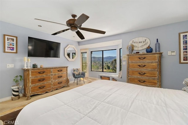 bedroom featuring ceiling fan, baseboards, and carpet