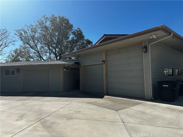 garage featuring concrete driveway