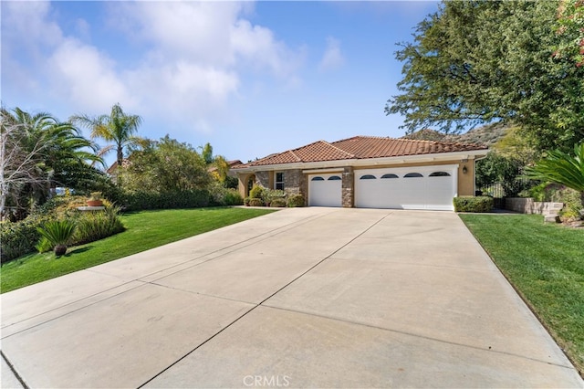 mediterranean / spanish house with driveway, stucco siding, a front lawn, a garage, and a tile roof