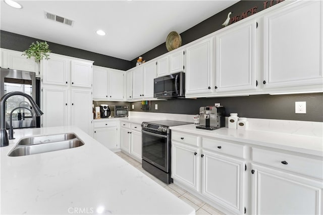 kitchen with visible vents, recessed lighting, stainless steel electric range, white cabinets, and a sink