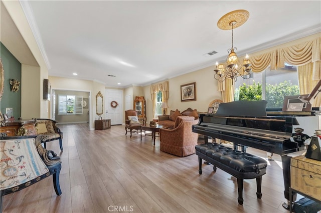 sitting room with visible vents, wood finished floors, recessed lighting, an inviting chandelier, and crown molding