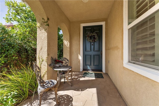 doorway to property with stucco siding