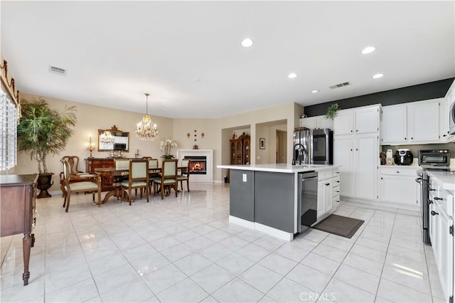 kitchen featuring visible vents, white cabinets, appliances with stainless steel finishes, and light countertops