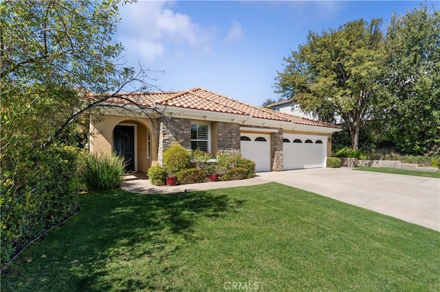 mediterranean / spanish-style house with a front lawn, a tiled roof, concrete driveway, stone siding, and an attached garage