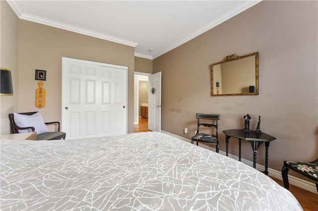 bedroom with a closet, wood finished floors, baseboards, and ornamental molding