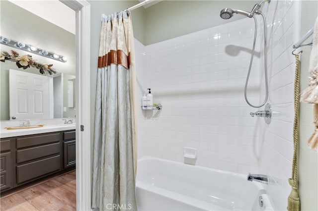 bathroom with vanity, wood finished floors, and shower / bath combo with shower curtain