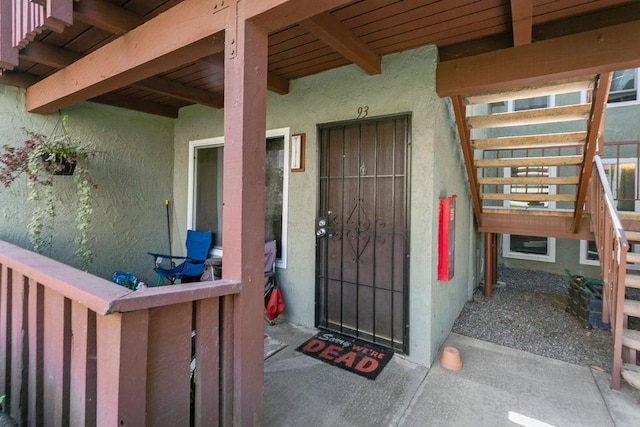 property entrance with stucco siding