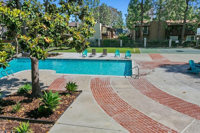 pool featuring a patio and fence