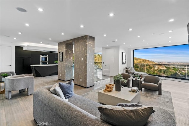 living room featuring a wall of windows and recessed lighting