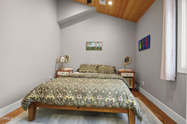 bedroom with dark wood-style flooring, wood ceiling, baseboards, and vaulted ceiling