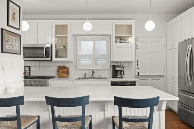 kitchen with white cabinetry, backsplash, and appliances with stainless steel finishes