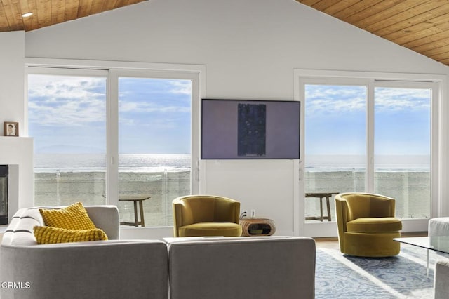 living area featuring wooden ceiling, a fireplace, and vaulted ceiling