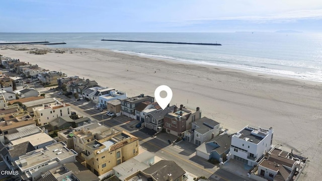 aerial view featuring a residential view, a water view, and a view of the beach