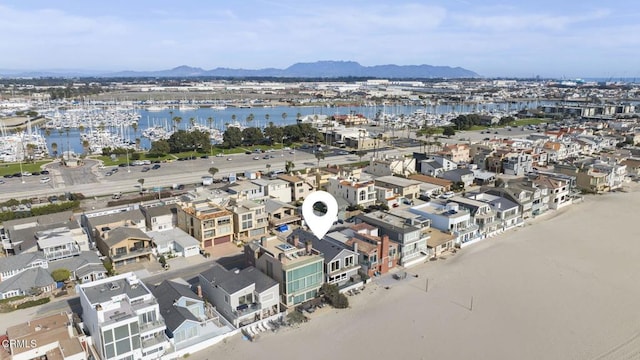 drone / aerial view featuring a water and mountain view