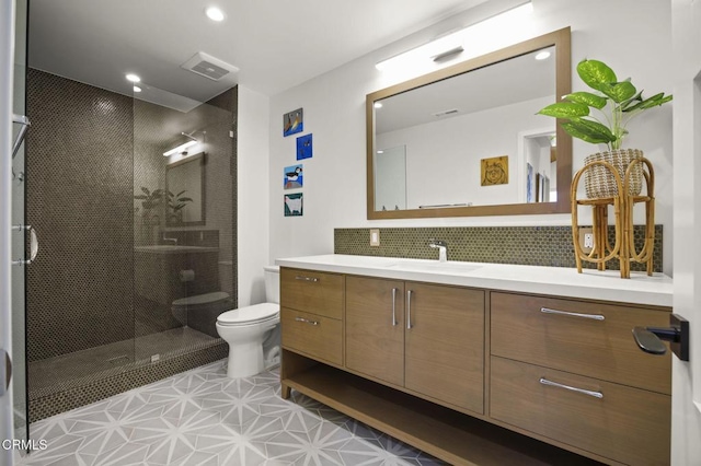 bathroom featuring visible vents, vanity, toilet, and a shower stall