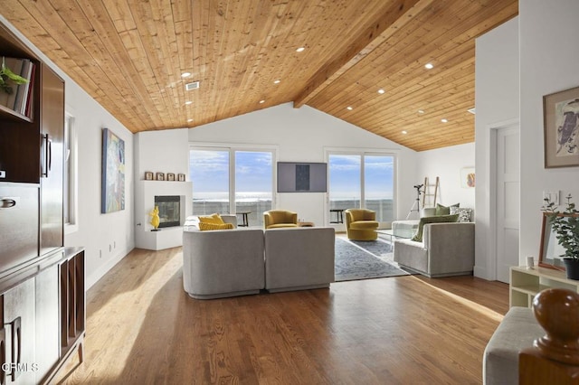 living area with a fireplace, wood ceiling, lofted ceiling with beams, and wood finished floors