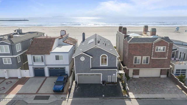 bird's eye view featuring a water view and a beach view