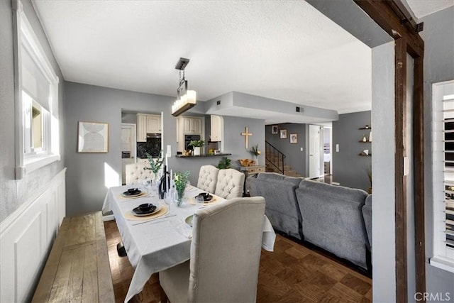 dining room featuring stairway and wood finished floors