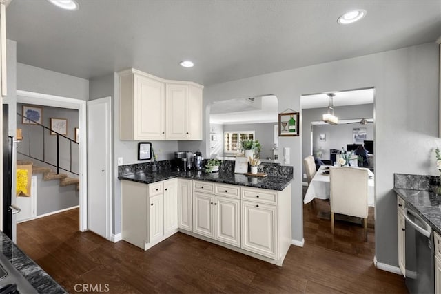 kitchen with recessed lighting, stainless steel dishwasher, dark wood-style floors, and white cabinetry