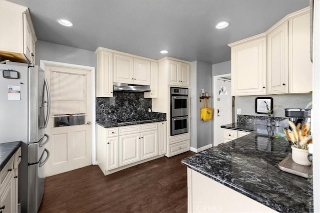 kitchen with recessed lighting, dark wood-style flooring, appliances with stainless steel finishes, under cabinet range hood, and backsplash