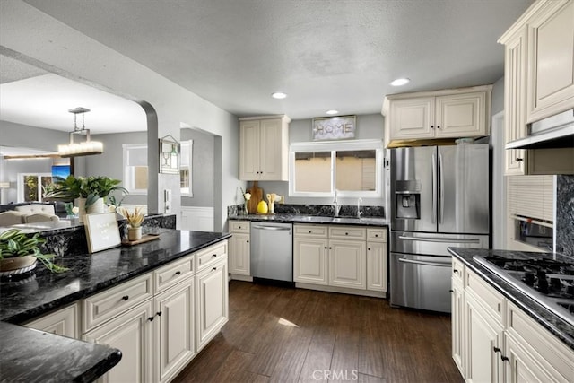 kitchen with extractor fan, dark wood finished floors, recessed lighting, appliances with stainless steel finishes, and a sink