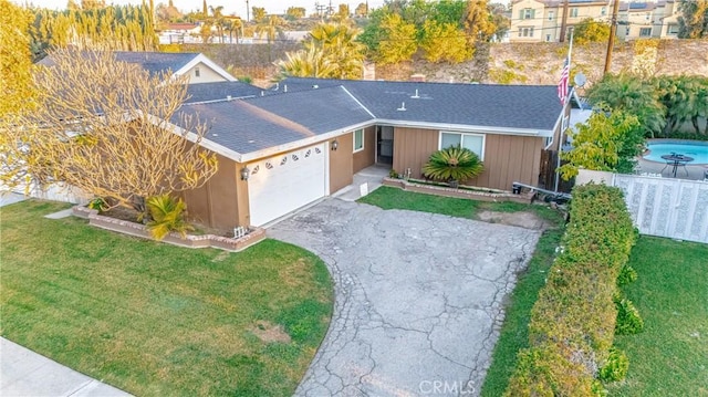 view of front facade featuring fence, driveway, roof with shingles, an attached garage, and a front lawn