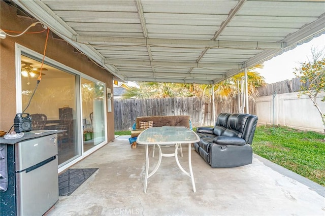 view of patio / terrace featuring outdoor dining space and fence