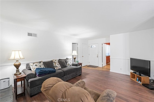 living room with visible vents and wood finished floors