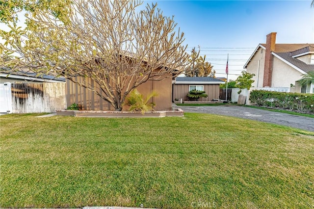 view of front of house with a front yard and fence