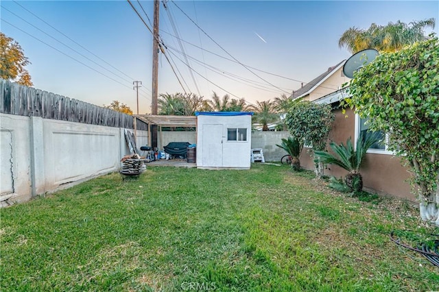 view of yard featuring an outbuilding and a fenced backyard