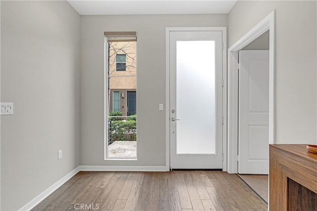 entryway with wood finished floors and baseboards