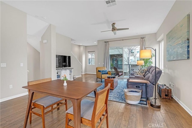 dining area featuring visible vents, baseboards, light wood-style floors, and ceiling fan