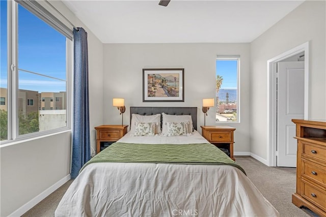 carpeted bedroom featuring ceiling fan and baseboards