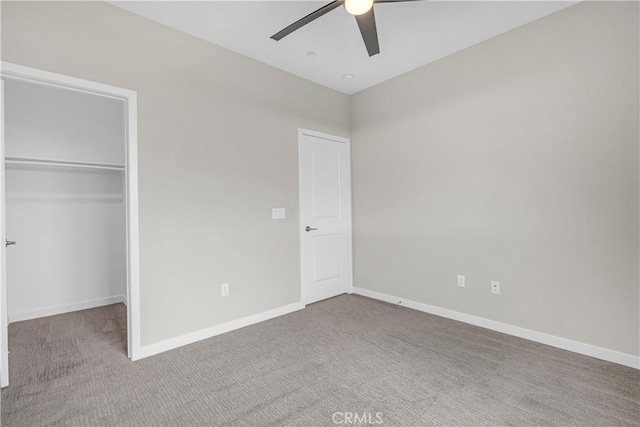 unfurnished bedroom featuring a closet, baseboards, and carpet floors