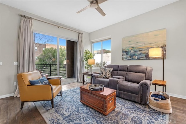 living area with wood finished floors, baseboards, and ceiling fan