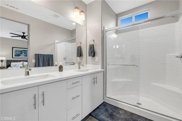 bathroom with visible vents, a shower stall, ensuite bath, and a sink