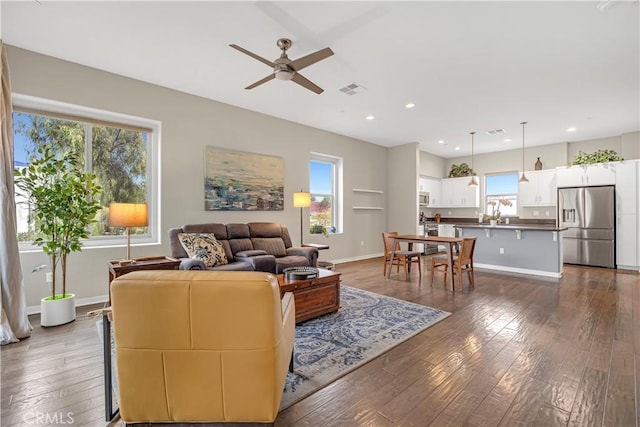 living room featuring recessed lighting, baseboards, dark wood-type flooring, and a ceiling fan