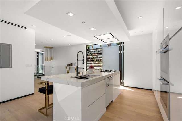 kitchen with electric panel, a sink, white cabinets, dishwasher, and modern cabinets