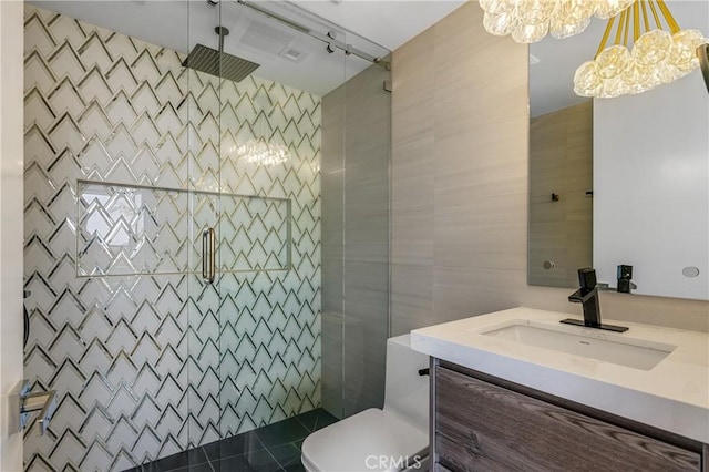 full bath featuring vanity, tile walls, a shower stall, and toilet