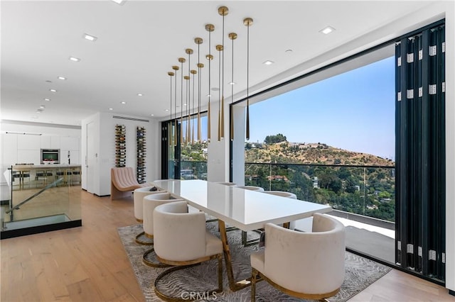 dining area featuring light wood finished floors and recessed lighting