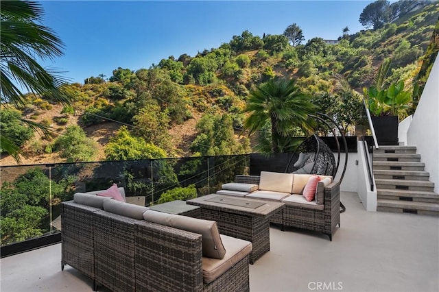 view of patio / terrace with stairs, fence, and outdoor lounge area