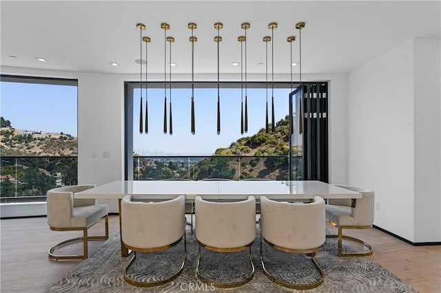 dining area featuring recessed lighting, light wood-style flooring, and baseboards